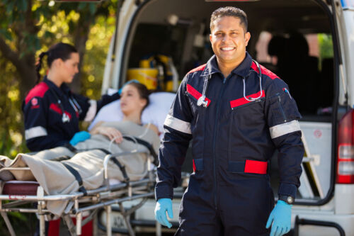 paramedic with colleague and patient on background